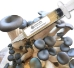 Close-up of a clear liquid culture syringe labeled ‘Myco Labs Liquid Culture Syringe’ placed in front of a cluster of blue oyster mushrooms with smooth, dark greyish-blue caps