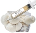 Close-up of a clear liquid culture syringe labeled ‘Myco Labs Liquid Culture Syringe’ placed in front of a cluster of white, pom-pom-like lion’s mane mushrooms growing from a cultivation bag.